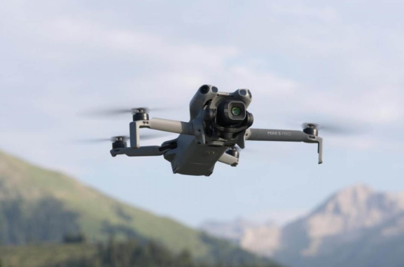 DJI Mini drone flying in the mountains